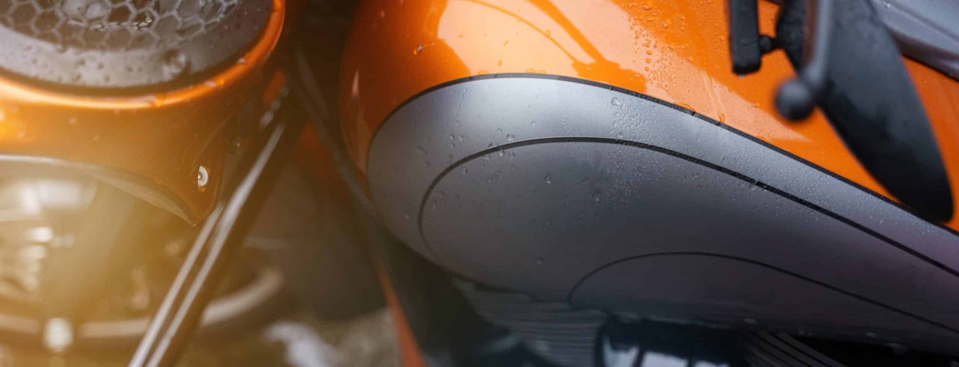 Close-up of a motorcycle fuel tank and speaker.